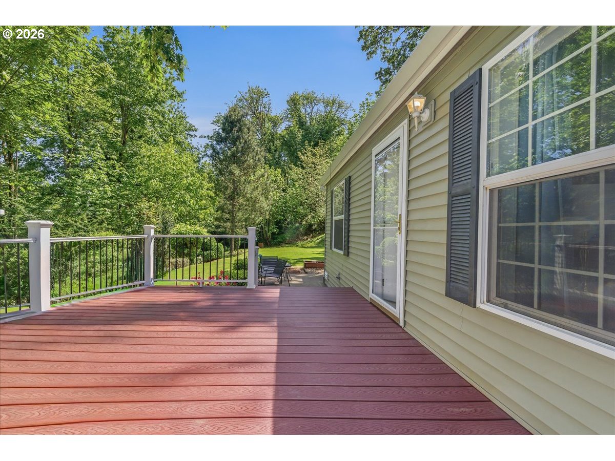 475 East 9th Street Rainier, OR 97048 - Photo 31 of 43 a view of a deck with a floor to ceiling window next to a yard