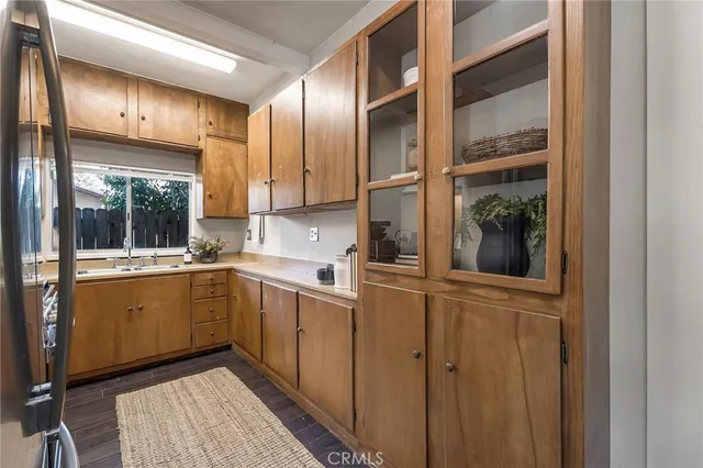 a kitchen with cabinets and window