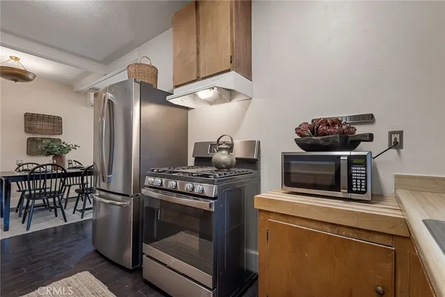 a kitchen with granite countertop a stove and a microwave