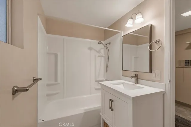 a bathroom with a sink mirror toilet and bathtub