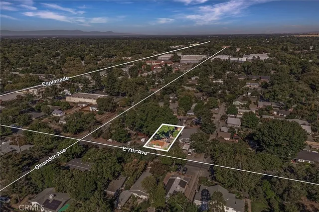 an aerial view of residential building with parking and yard