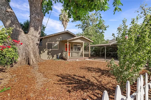 a front view of a house with a garden