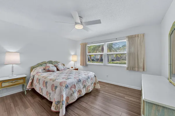 a bedroom with a bed lamp and window