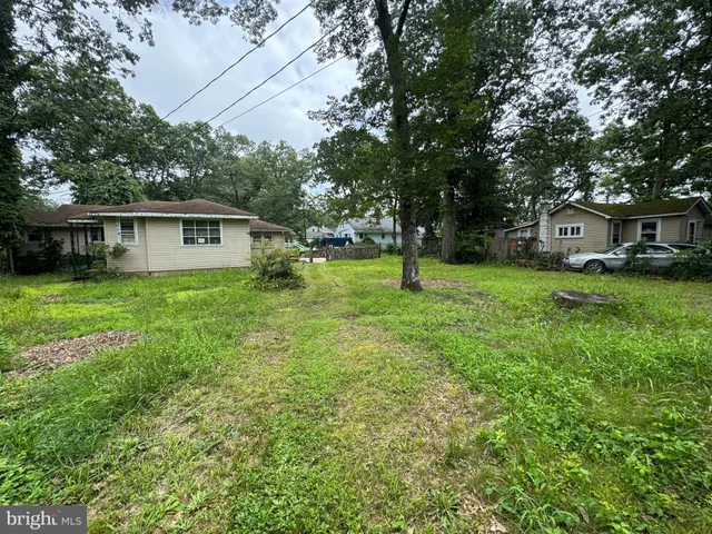 a view of a house with a yard and sitting area