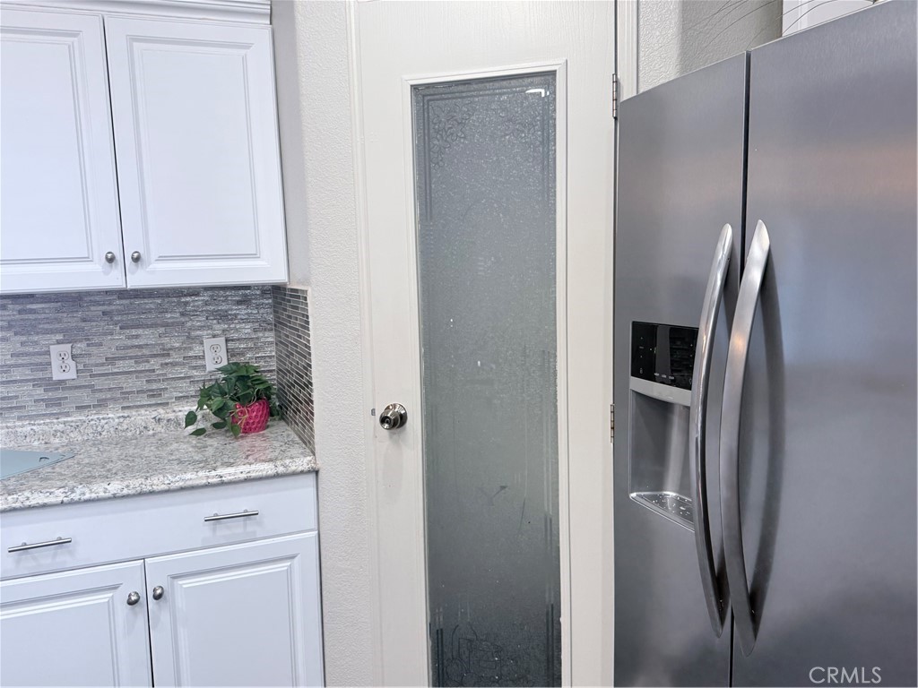 1855 Riverside, Unit 405 Ontario, CA 91761 - Photo 13 of 25 a kitchen with stainless steel appliances granite countertop a refrigerator and a sink
