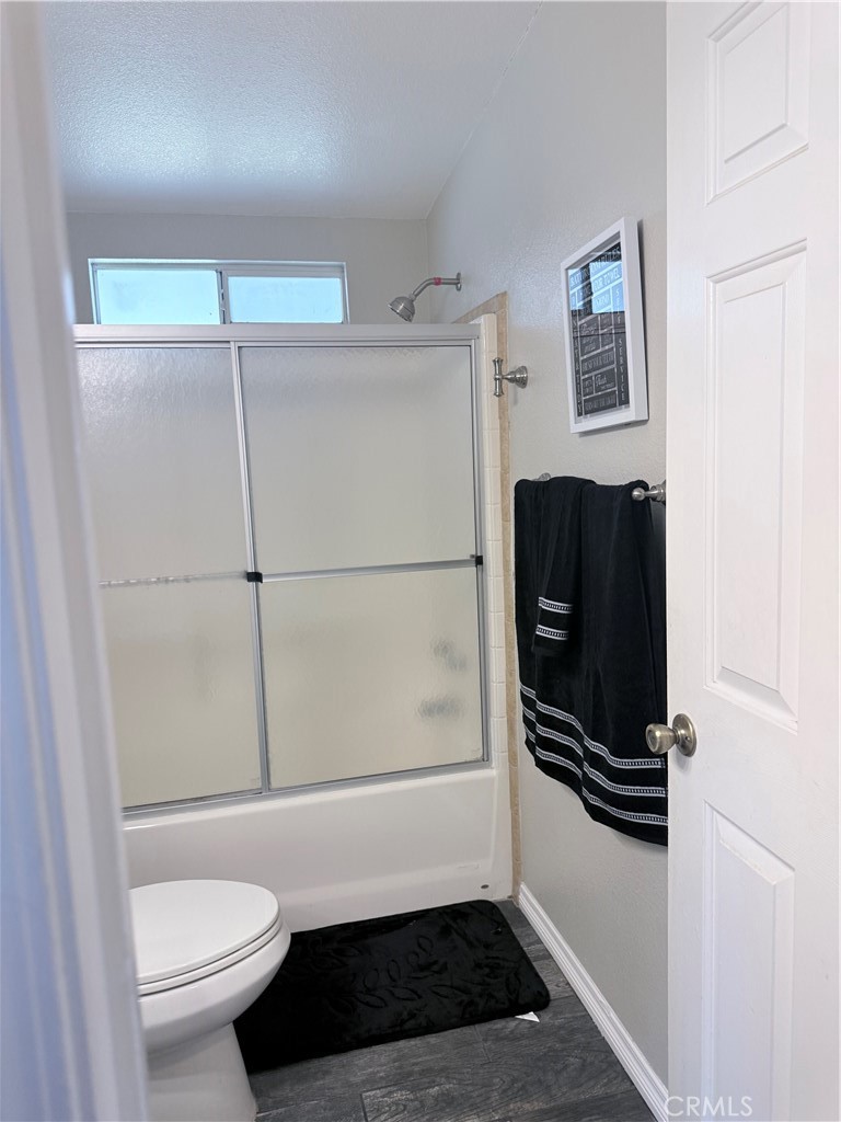 1855 Riverside, Unit 405 Ontario, CA 91761 - Photo 18 of 25 a bathroom with a shower a toilet and a sink