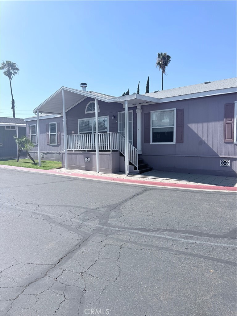 1855 Riverside, Unit 405 Ontario, CA 91761 - Photo 2 of 25 a view of house with a yard