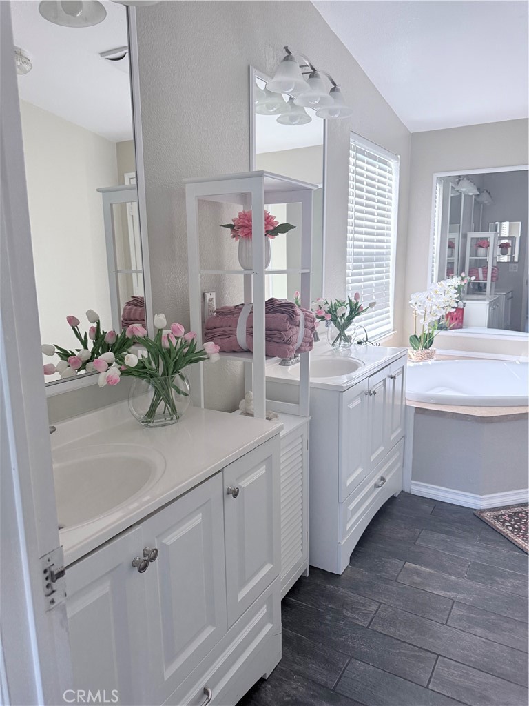 1855 Riverside, Unit 405 Ontario, CA 91761 - Photo 21 of 25 a bathroom with a sink a vanity and mirror