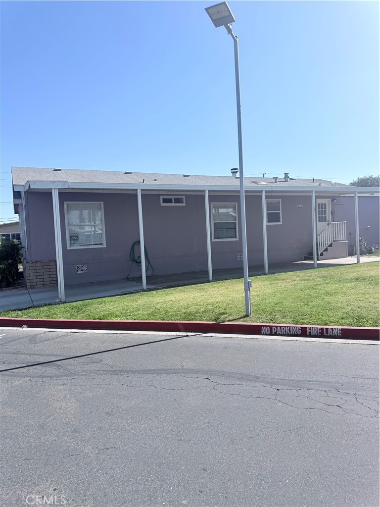 1855 Riverside, Unit 405 Ontario, CA 91761 - Photo 23 of 25 a view of a house with a yard and palm trees
