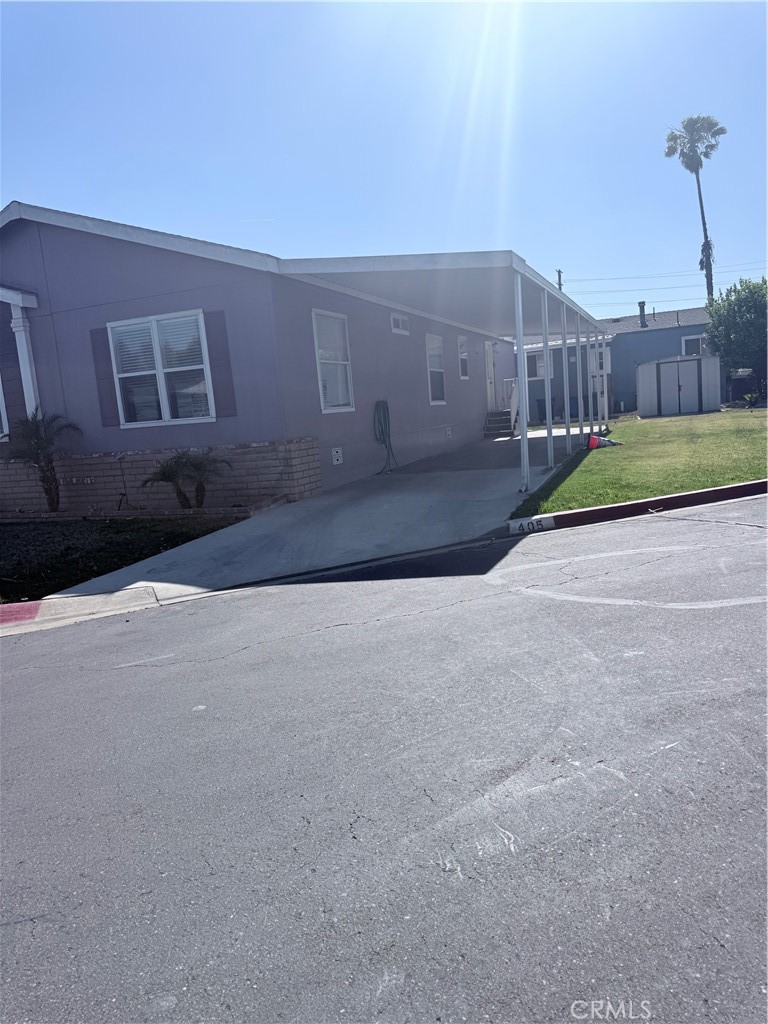 1855 Riverside, Unit 405 Ontario, CA 91761 - Photo 25 of 25 a view of a house with a yard
