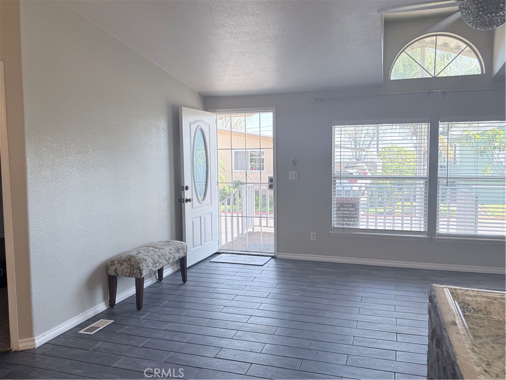 1855 Riverside, Unit 405 Ontario, CA 91761 - Photo 3 of 25 a view of an empty room with wooden floor and a window