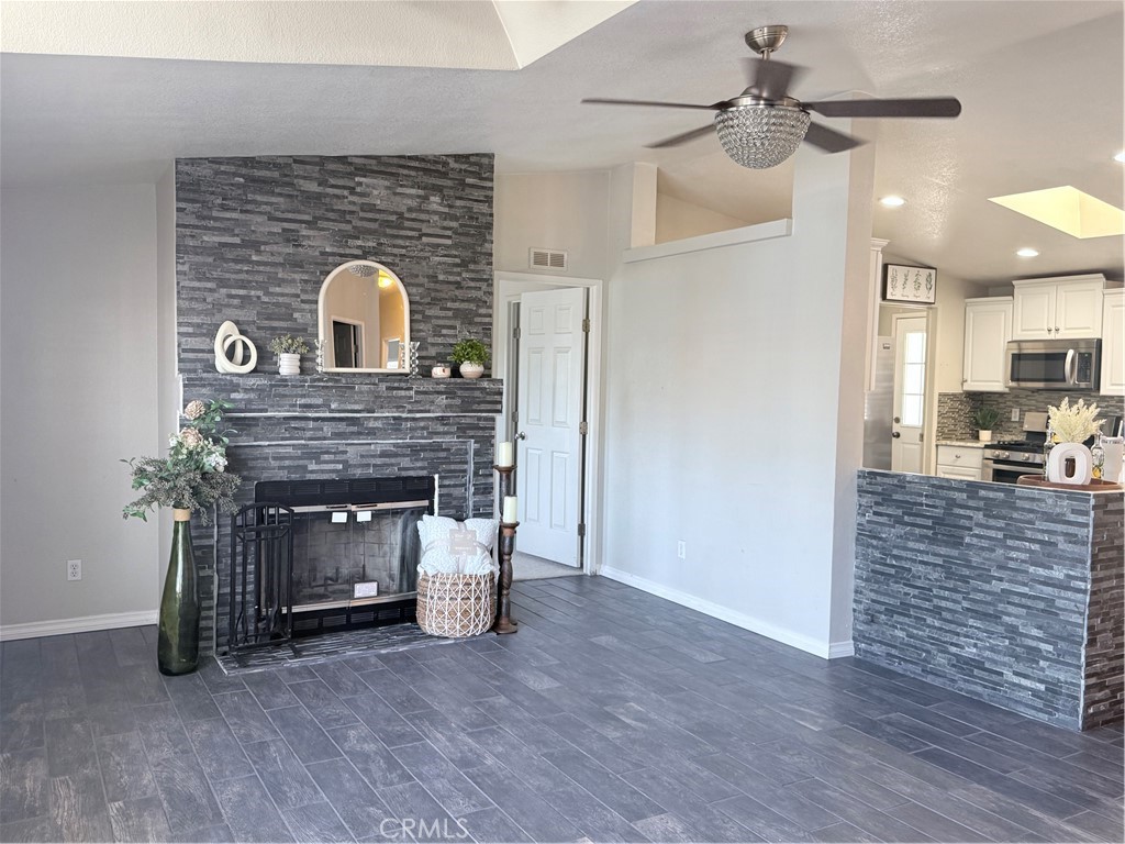 1855 Riverside, Unit 405 Ontario, CA 91761 - Photo 5 of 25 a view of a livingroom with a fireplace and cabinet