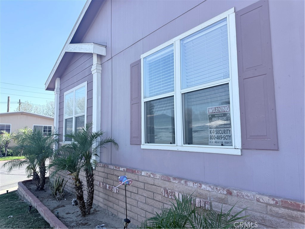 1855 Riverside, Unit 405 Ontario, CA 91761 - Photo 8 of 25 a view of a house with a yard and potted plants