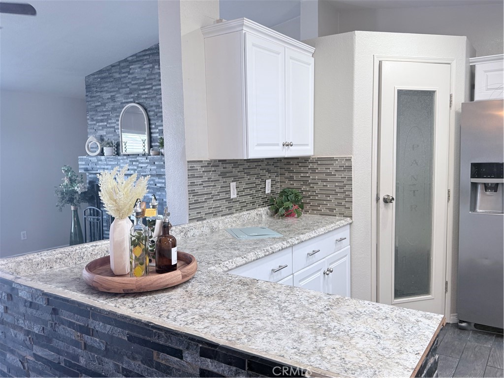 1855 Riverside, Unit 405 Ontario, CA 91761 - Photo 9 of 25 a kitchen with a sink and a stove with wooden floor