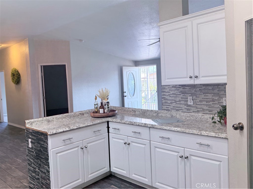 1855 Riverside, Unit 405 Ontario, CA 91761 - Photo 10 of 25 a kitchen with granite countertop white cabinets and a granite counter tops