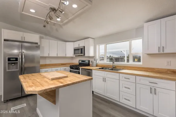 a kitchen with a stove a sink and a refrigerator