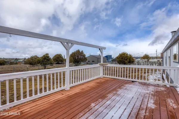 a view of a dry yard with wooden fence
