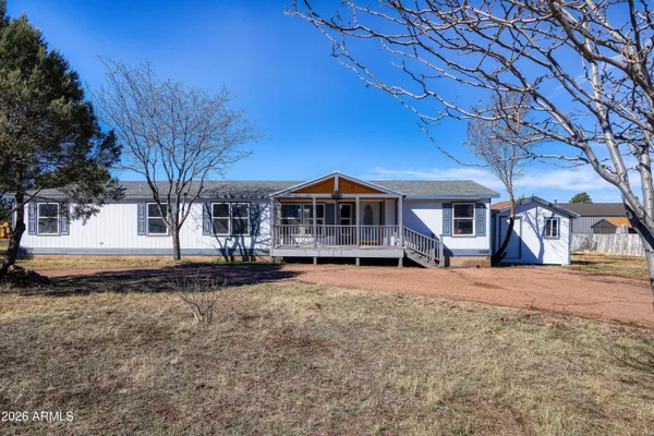 a view of a house with wooden deck