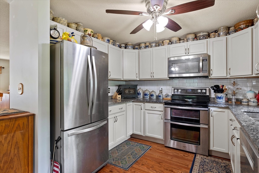 8 Stone Valley Road Orange, MA 01364 - Photo 11 of 27 a kitchen with stainless steel appliances a stove a refrigerator and a sink