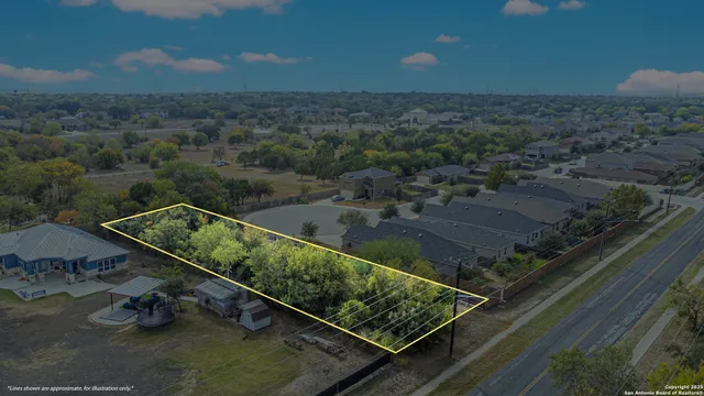 an aerial view of a residential houses with outdoor space