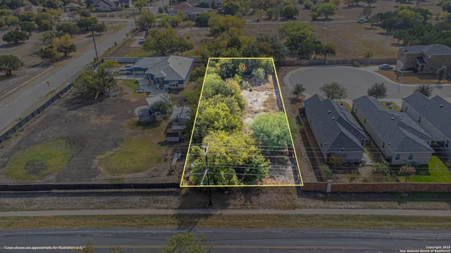 an aerial view of a house with a yard