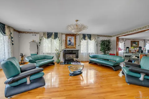 a spacious bedroom with a bed and wooden floor