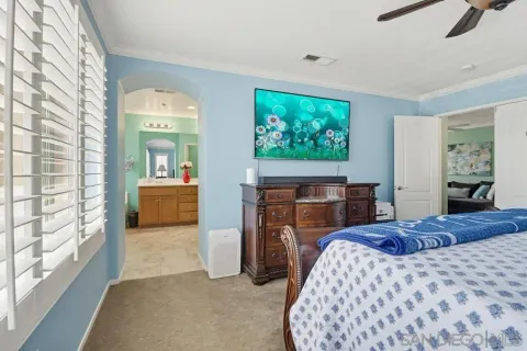 a bedroom with a bed and a television