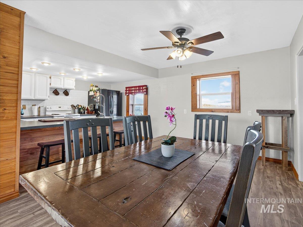 2588 West Sales Yard Road Emmett, ID 83617 - Photo 16 of 50 Dining space with dark wood-style floors and ceiling fan