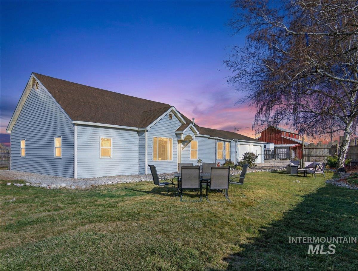2588 West Sales Yard Road Emmett, ID 83617 - Photo 3 of 50 Back of house at dusk featuring a patio