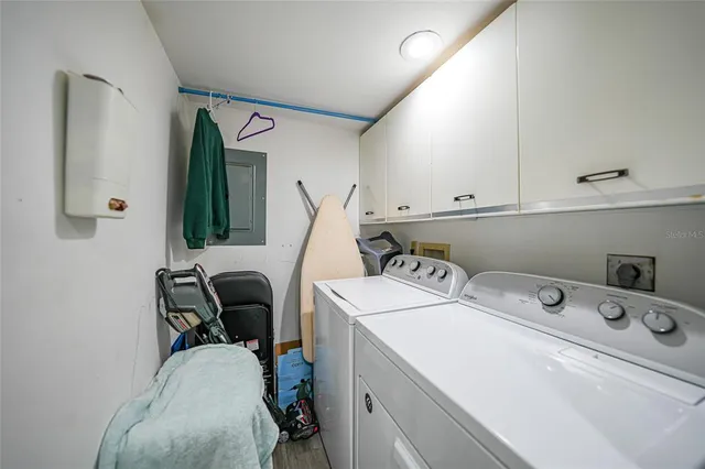 a bedroom with a large bed and a flat tv screen on dresser
