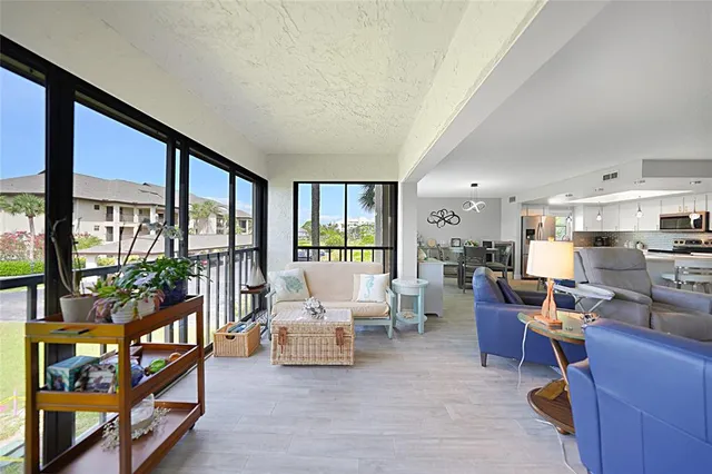 a view of a city from a balcony with furniture