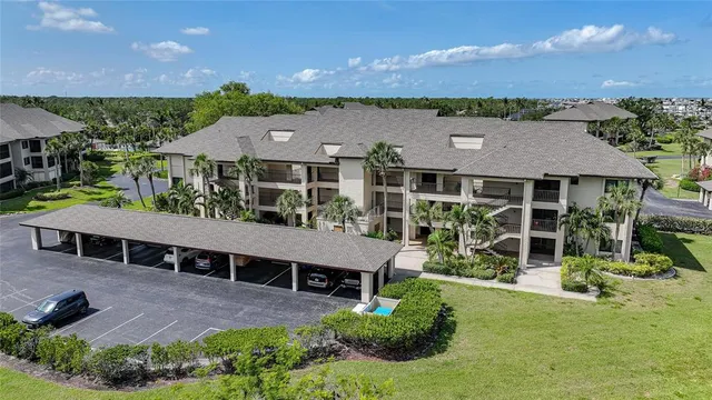 a balcony with chairs and a potted plant