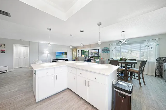 a kitchen with stainless steel appliances white cabinets a sink and a stove