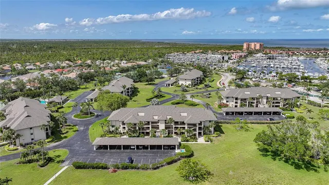 an aerial view of multiple houses with a yard
