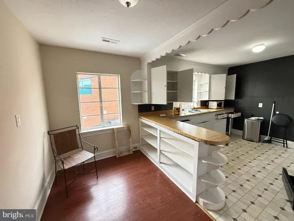 a kitchen with granite countertop a stove a sink and a refrigerator