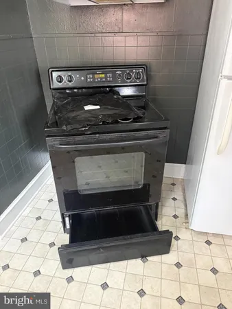 a stove top oven sitting inside of a kitchen