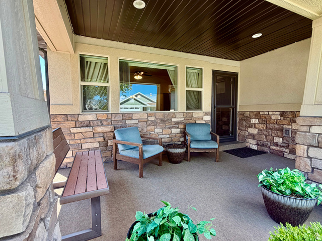 1204 South 1150th Street West Payson, UT 84651 - Photo 2 of 26 Large Covered front porch featuring a stone and stucco facade, a dark wood-finish ceiling, recessed lighting, and an entryway with a screen door