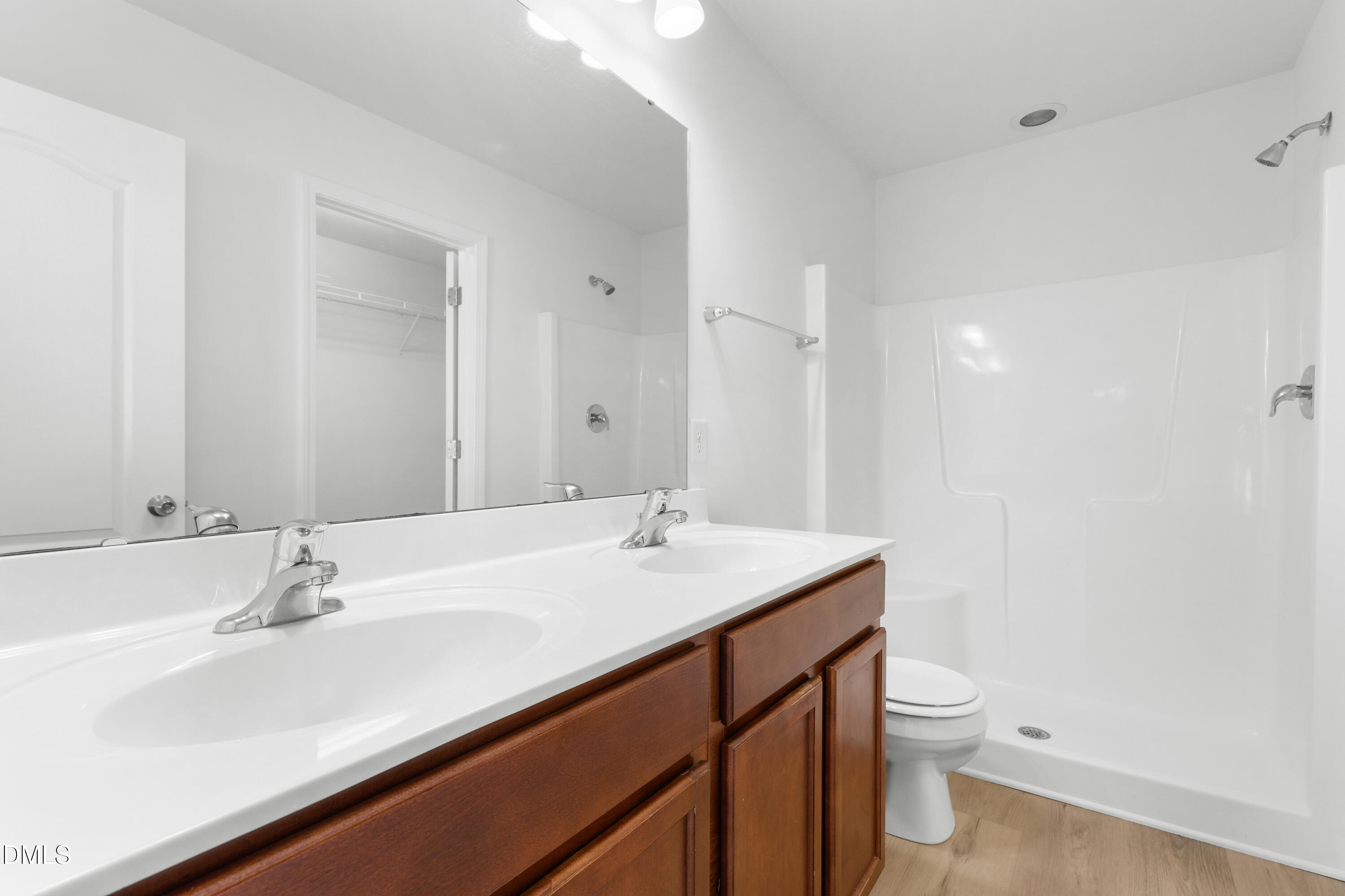 4400 Hillsgrove Road Wake Forest, NC 27587 - Photo 23 of 49 a bathroom with a sink a toilet a mirror and vanity