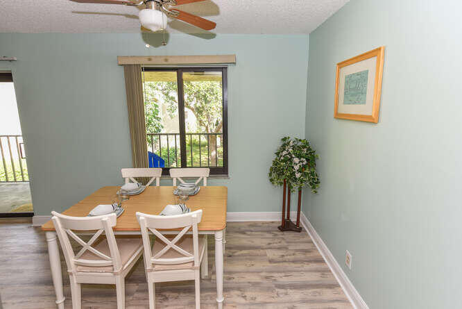 150 Pineview Road, Unit L6 Jupiter, FL 33469 - Photo 11 of 31 a view of a dining room with furniture window and wooden floor