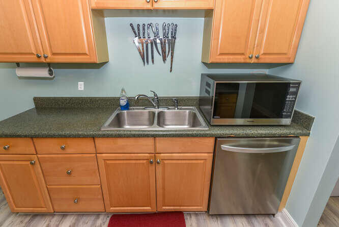 150 Pineview Road, Unit L6 Jupiter, FL 33469 - Photo 15 of 31 a kitchen with granite countertop cabinets and a sink
