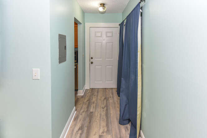 150 Pineview Road, Unit L6 Jupiter, FL 33469 - Photo 17 of 31 a view of a hallway with wooden floor