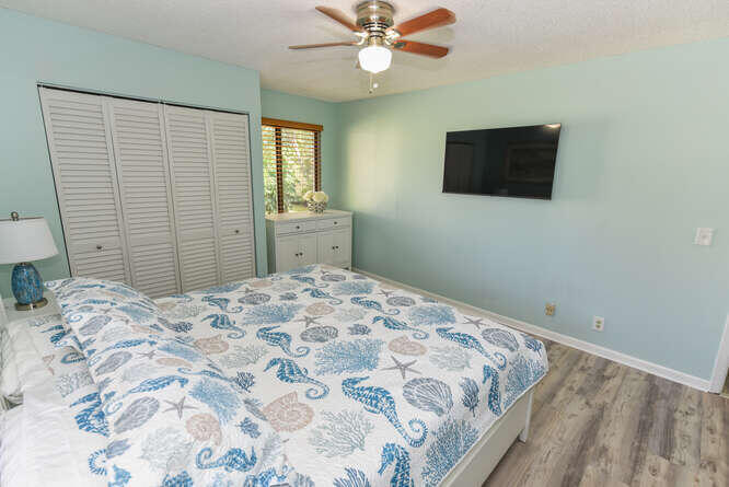 150 Pineview Road, Unit L6 Jupiter, FL 33469 - Photo 24 of 31 a bedroom with a bed and a flat screen tv