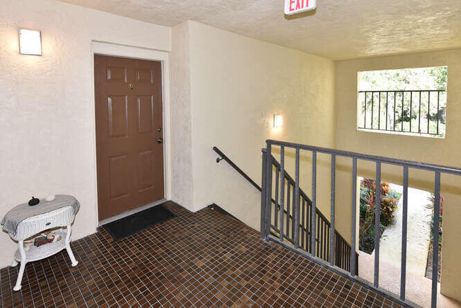 150 Pineview Road, Unit L6 Jupiter, FL 33469 - Photo 27 of 31 a view of a hallway with wooden floor and windows