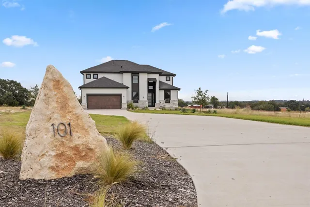 a view of swimming pool with outdoor seating and house in the background