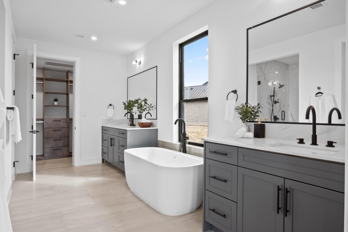 101 Fall Drive Georgetown, TX 78633 - Photo 18 of 40 a bathroom with a double vanity sink mirror and tub