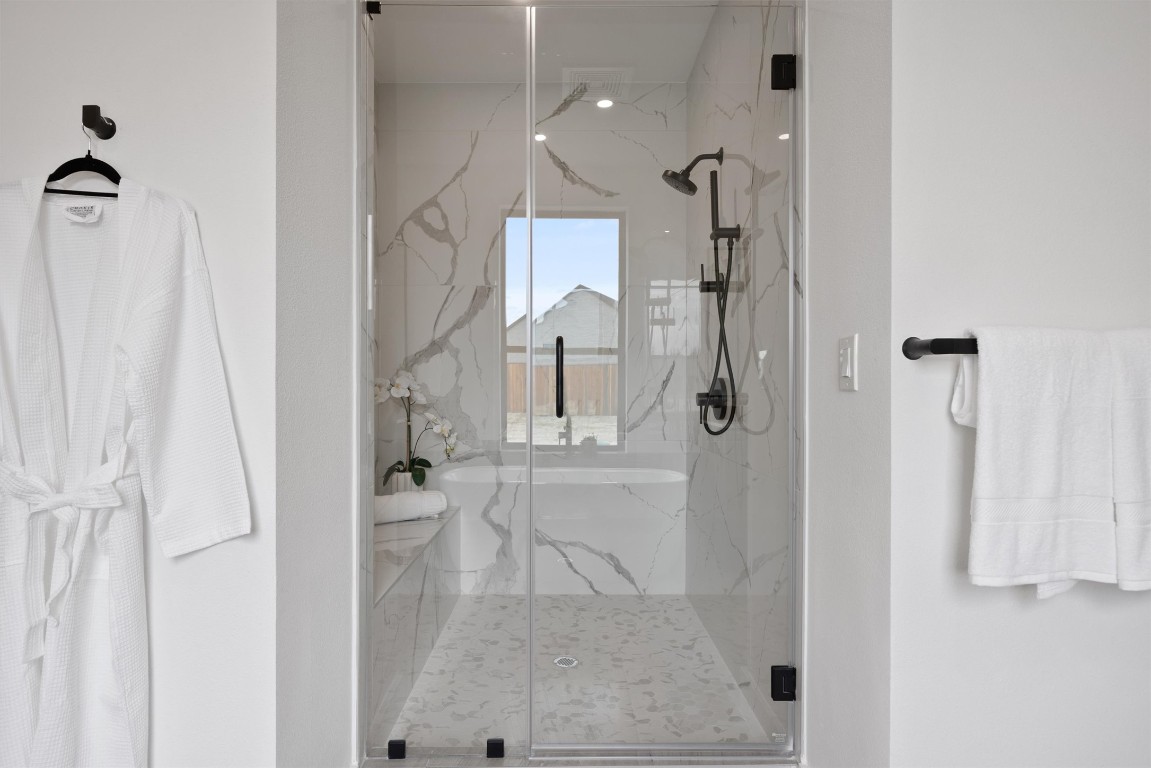 101 Fall Drive Georgetown, TX 78633 - Photo 19 of 40 a bathroom with a glass shower door