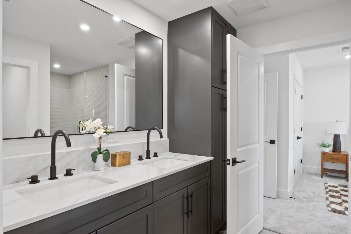 101 Fall Drive Georgetown, TX 78633 - Photo 29 of 40 a bathroom with double vanity sinks and a mirror