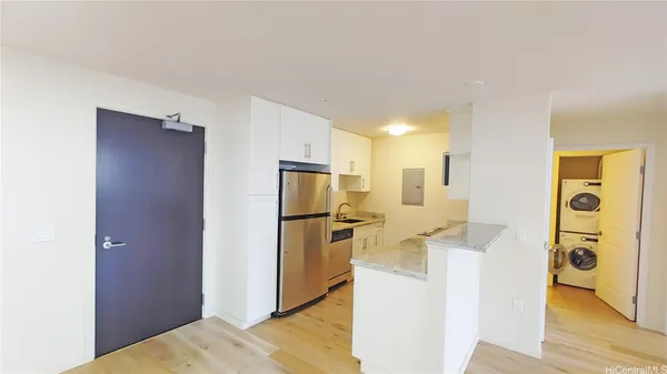 a kitchen with stainless steel appliances granite countertop a refrigerator and a stove