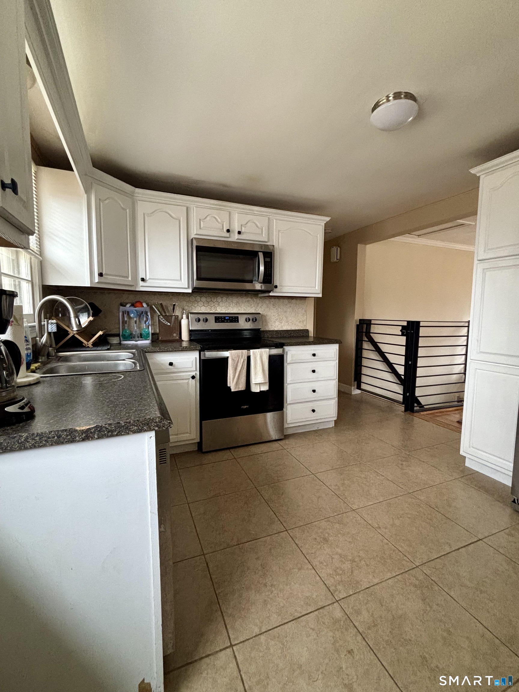 117 Arden Road Waterbury, CT 06708 - Photo 9 of 30 a kitchen with stainless steel appliances a sink a stove top oven a counter space and cabinets