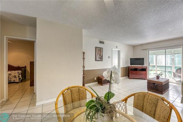 a living room with furniture a flat screen tv and a large window